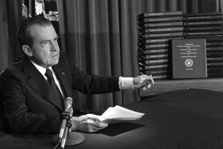 President Richard M. Nixon points to transcripts of White House tapes on April 29, 1974, after announcing that he would turn them over to House impeachment investigators.