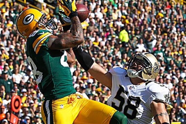 The Packers beat the winless Saints, 28-27, Sunday. (Mike Roemer/AP)