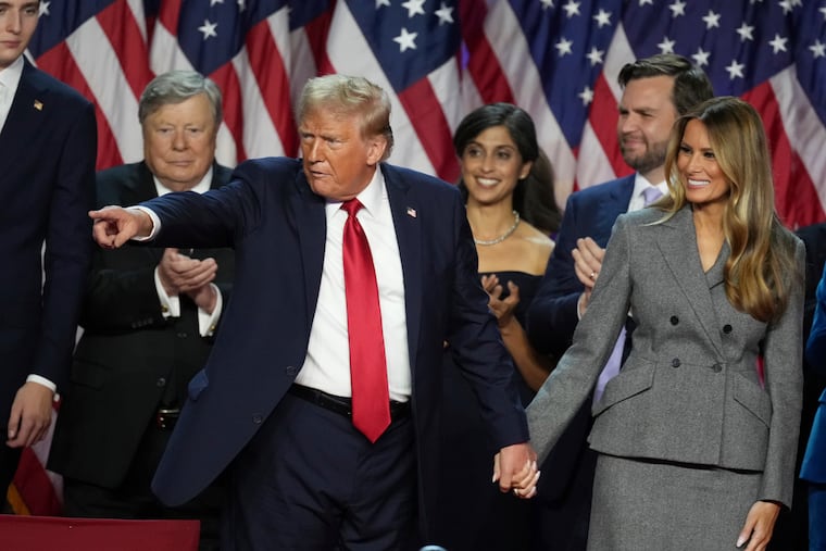 Republican Presidential nominee former President Donald Trump holds hands with former first lady Melania Trump after speaking to supporters at the Palm Beach County Convention Center during an election night watch party, Wednesday, Nov. 6, 2024, in West Palm Beach, Fla.