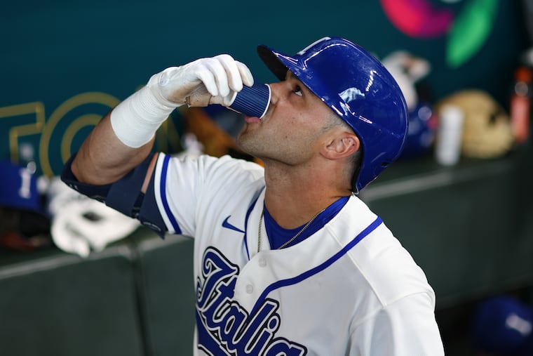 Phillies prospect Dante Nori of Team Italy drinks an espresso shot in the dugout after hitting a home run against Brazil on Saturday in Houston.