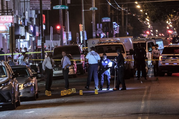 Police on the scene near Wyoming Avenue and D Street where five people were wounded in a drive-by shooting on Tuesday.