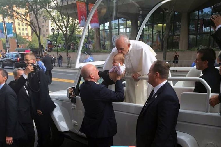 Pope Francis gives little Gianna Masciantonio a kiss during his visit to Philly in September.
