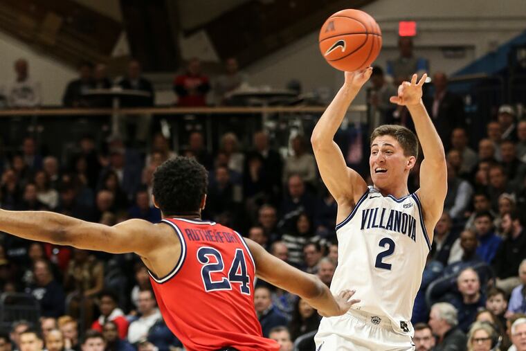 Villanova's Collin Gillespie passing over St. John's Nick Rutherford during the first half Wednesday.