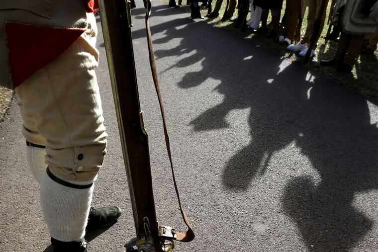 A reenactor stands guard before the start of the annual reenactment of Washington's crossing of the Delaware during the Revolution.