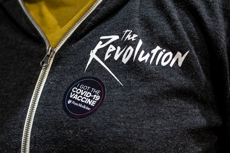 Kathy Balsley, of West Philadelphia, puts on her sticker to show she has received vaccine at TLA from Pennsylvania Hospital on Friday, March, 5, 2021.