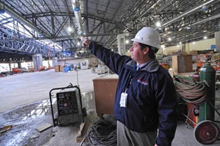 Joseph J. Resta, executive director of the Convention Center’s expansion, points out details of the main floor and roof of the $786 million project. A March 2011 opening is anticipated. (Clem Murray / Staff Photographer)