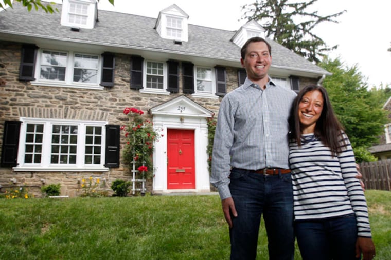 Brett, left, and Jen, right, Cohen in front of their Wynnewood home. The Cohens' three-story stone Colonial was built in 1927. ( Michael Bryant / Staff Photographer )