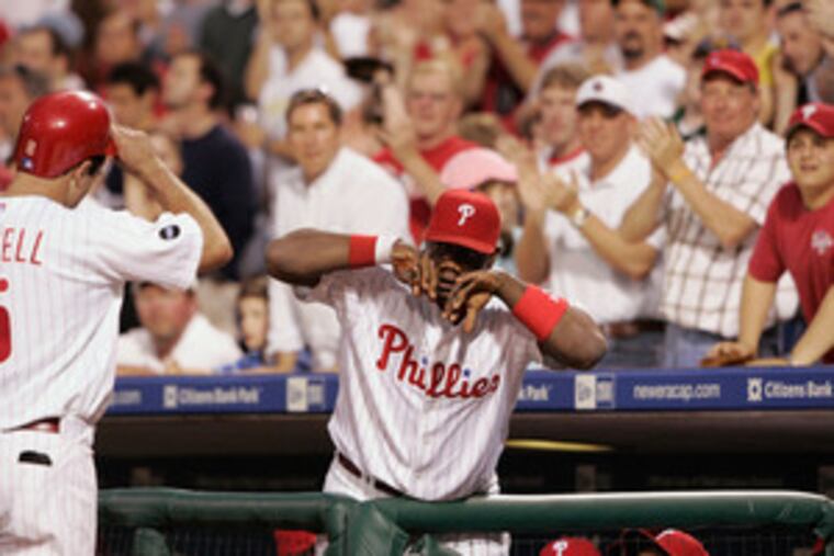 "You have to look at the production of the middle of the lineup, and guys have to pick it up," says Pat Burrell, being congratulated by Ryan Howard after homering. "I have no problem with that."