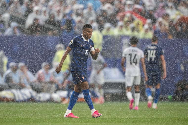 France forward Kylian Mbappé walks off the field during a thunderstorm delay at the end of the first half against Iraq Monday night at Lincoln Financial Field.