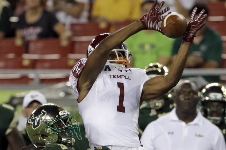 Temple wide receiver Adonis Jennings (1) makes a catch in front of South Florida cornerback Deatrick Nichols (3) during the first half Thursday, Sept. 21, 2017.