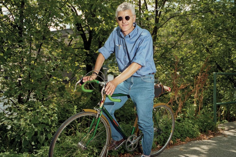 Steven Rea , author of "Hollywood Rides a Bike" and Inquirer film critic, on one of his 14 bicycles: A wedding of the wheels and the reels.