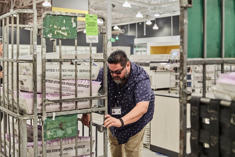 FILE — A worker moves boxes with votes at the Ballot Processing Center in the City of Industry, Calif., Nov. 4, 2025.