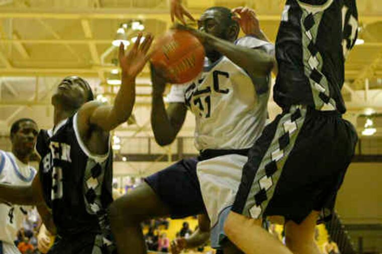 Franklin Learning Center's Basir Fulmore (center) battles Strath Haven's Calvin Newell (left) and Jack Roberts for a rebound. Newell scored 32 points to lead the Panthers to a 76-66 victory in the first round of the Class AAA playoffs.