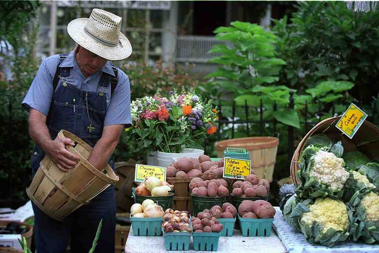 Myron Kressman at Trauger's Farm Market in 2002 in Kintnersville, Bucks County,where he was selling vegetables. Some farmers' marketers complain that the state's Act 106 "takes away from the market experience."