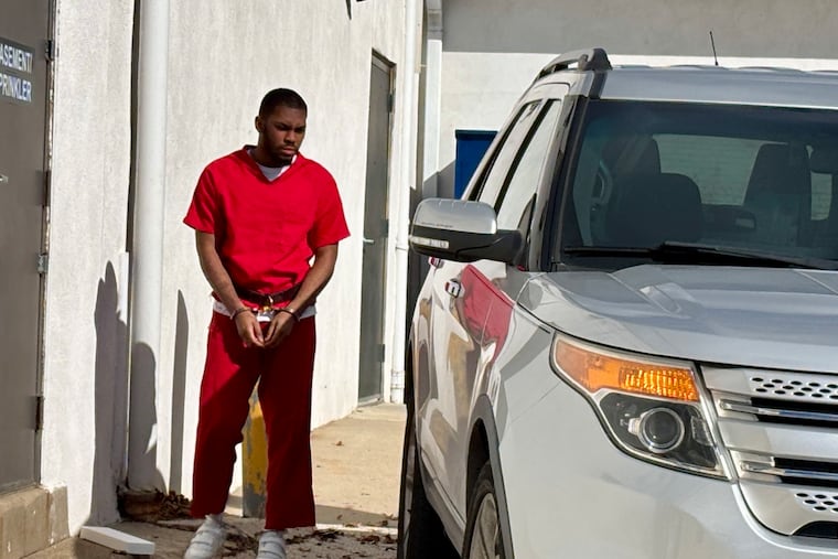Kaiheem Williams awaits being placed into a state constable's vehicle after his preliminary hearing Tuesday in the shooting death of his girlfriend, Taniyah Bell.