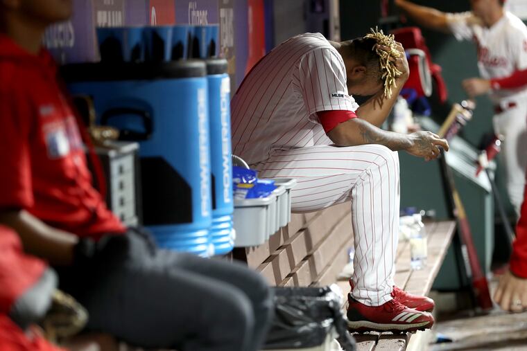Edubray Ramos holds his head in his hands after giving up a home run that allowed the Nationals to tie it in the ninth.