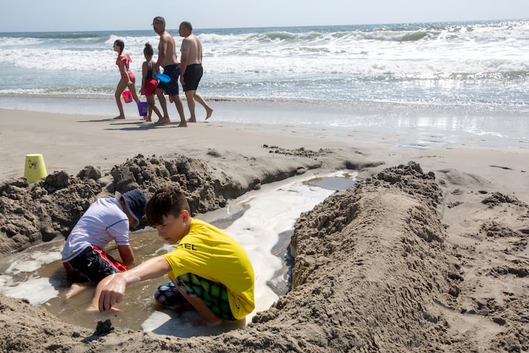 Jeb Bieber sits in the sand with his brother, James, at Strathmere Beach on Monday, Sept. 2, 2019.