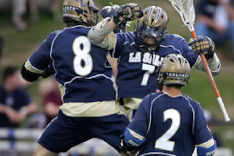La Salle's Pete Schwartz (8) celebrates one of his two goals with teammate Randy Forster as Conrad Ridgway (2) looks on. Ridgway also scored a goal for the triumphant Explorers.