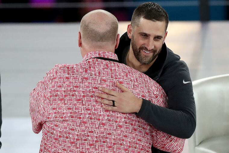 Chiefs head coach Andy Reid (left) and Eagles head coach Nick Sirianni (right) hug on the stage at the Super Bowl LVII Opening Night event at the Footprint Center on Monday, Feb. 06, 2023, in Phoenix, Ariz. .
