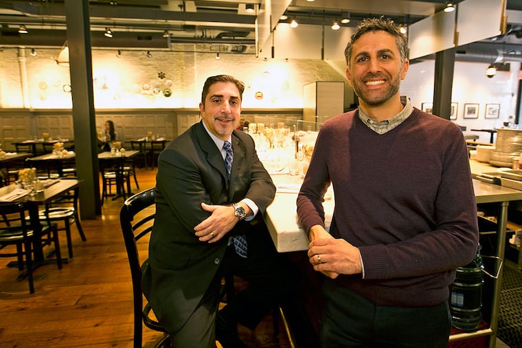 At Sansom Street Oyster House, Dan Hernandez, left, and owner Sam Mink make sure that managers, servers and oyster shuckerswill get a unique benefit, a 401-K plan with a company match.