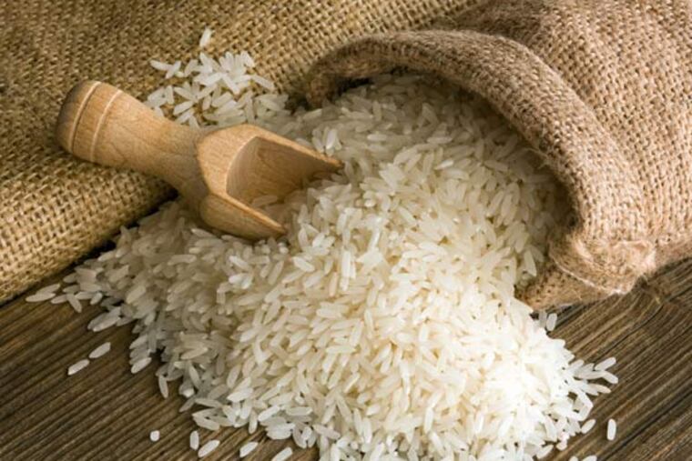 Uncooked white rice in a burlap sack.