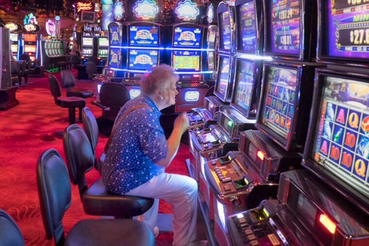 A gambler plays the slots on a nearly empty casino floor at Revel on Monday.