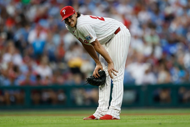Phillies pitcher Aaron Nola kneels over after getting hit by a line drive in the sixth inning against the Toronto Blue Jays on Saturday.