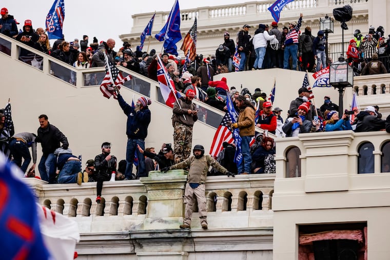 Pro-Trump supporters storm the U.S. Capitol following a rally with President Donald Trump on Wednesday, Jan. 6, 2021 in Washington, D.C. Congress held a joint session today to ratify President-elect Joe Biden's 306-232 Electoral College win over President Donald Trump. A group of Republican senators said they would reject the Electoral College votes of several states unless Congress appointed a commission to audit the election results.