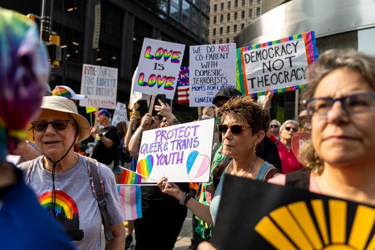 Denise Lewis, 61, of Collingswood, N.J., along with others, gathered outside the Marriott Hotel along 12th and Market Street in Center City Philadelphia to protest outside Moms for Liberty conference on Friday.
