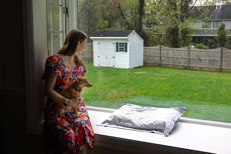 Valerie Rossi and her chihuahua, Luna, in the large kitchen picture window of her Cherry Hill. Rossi plans to build a patio and gardens in the backyard soon. For "How I Bought This House" feature.