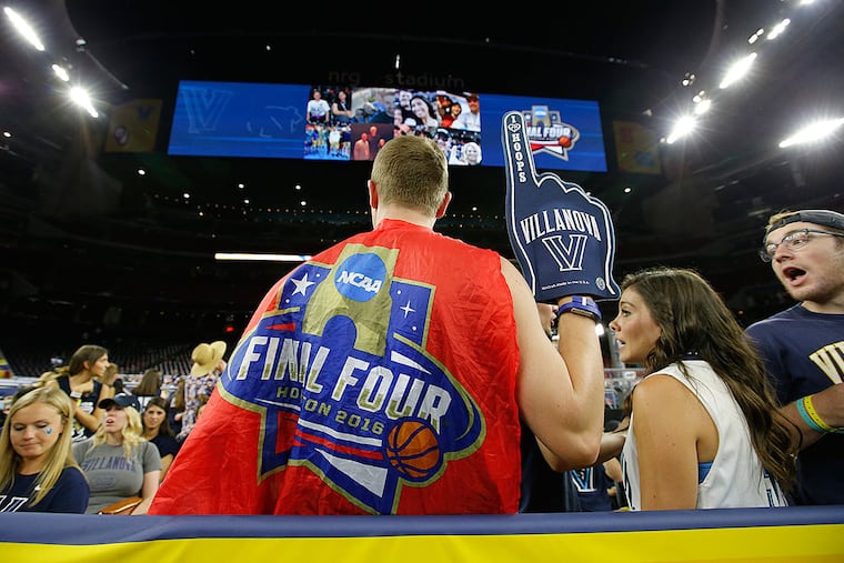 Villanova senior Tyler Amspacher uses a Final Four banner as a cape.