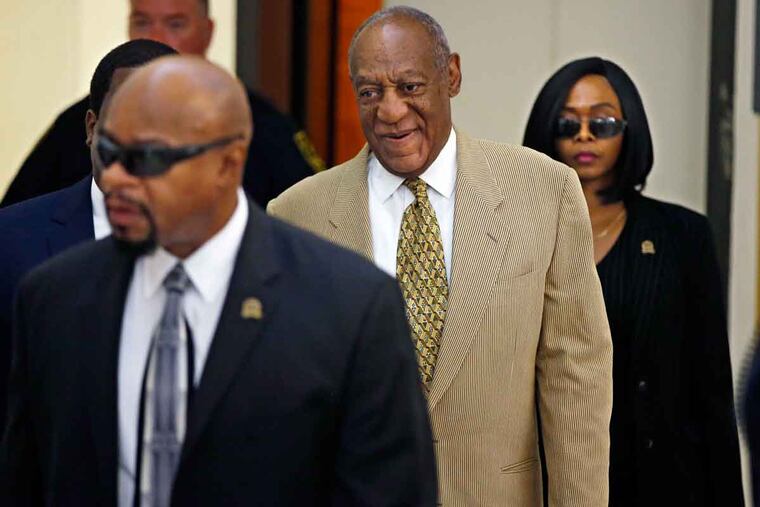 Bill Cosby is surrounded by members of his security team as he walks to Courtroom A in the Montgomery County Courthouse on Thursday, July 7, 2016.