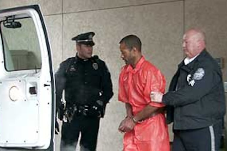 Mark O'Donnell being put into a police van to go to his arraignment this afternoon.