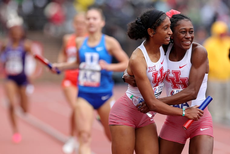 Michaela Mouton, left, is hugged by Sydni Townsend after Houston won the college women's 4x400m during day 3 of the 128th Penn Relays on April 27, 2024. Townsend attend Neuman Goretti.