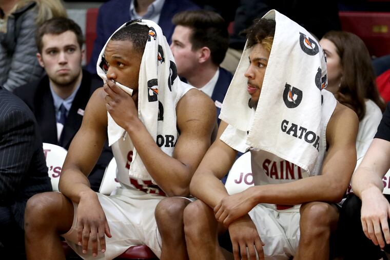 Charlie Brown (right) and Chris Clover on the bench against Rhode Island on Tuesday.