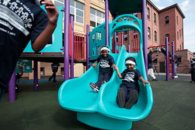 Rajene Warren (left) and Saana Parker at St. Malachy School in North Philadelphia, a pioneering self-sustaining school for low-income students for nearly 30 years that is slated to close. (David Swanson/Staff)
