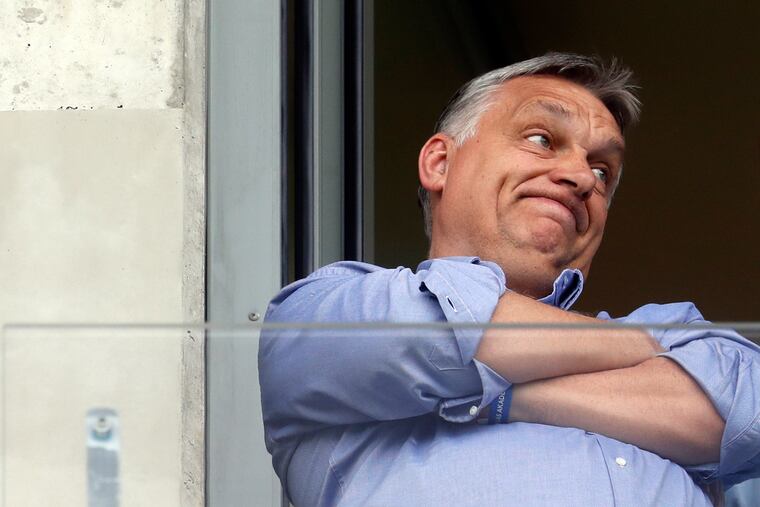 Hungarian Prime Minister Viktor Orban, left, watches a soccer game in his hometown of Felcsut, Hungary May 19, 2019, ahead of the European election on May 26.