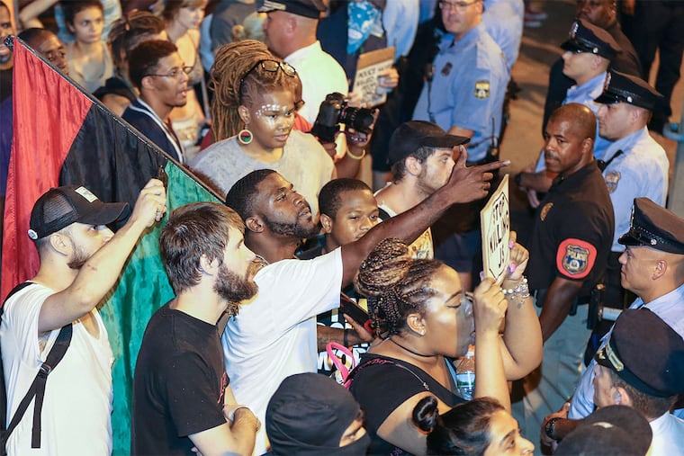 Philly Coalition for REAL Justice protesters confront police outside the 24th and 25th District headquarters. A multiracial crowd marched Saturday night in what they said was an effort to "disrupt" and "shut down" police activity and area traffic.