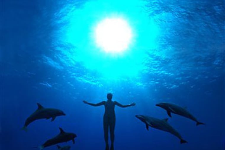 Mandy-Rae Cruickshank is surrounded by dolphins as she ascends in a scene from "The Cove." (AP Photo/Roadside Attractions)