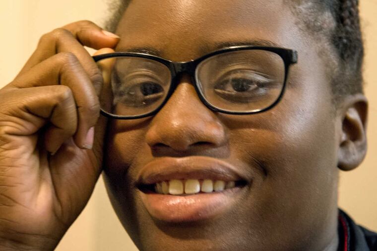 La'Shawna Johns, 14, with her broken glasses at home November 3, 2016. She recently went to a vision clinic at Wills Eye Hospital, and is now awaiting new glasses.