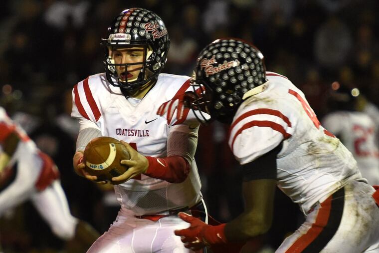 Coatesville’s Ricky Ortega hands off to Aaron Young against North Penn in a PIAA District 1 Class 6A semifinal last season.