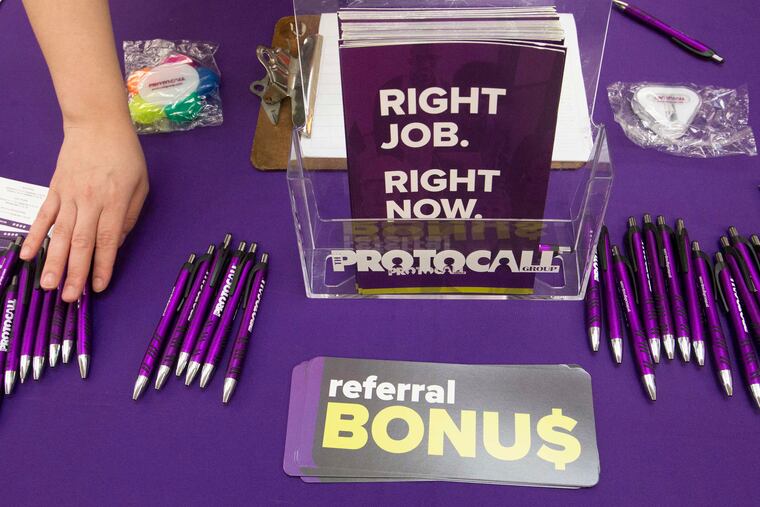 FILE photo shows Pam Ranson, recruiter for the Protocol Group Company, arranging her display table during the Recruitment Queen Job Fair at the Oxford Valley Mall in Langhorne.