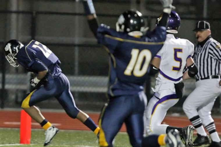 West Catholic's Robert Hollomon (left) takes the ball in for a touchdown in the second quarter. He scored on a shovel pass from QB Curtis Drake. The Burrs' Quran Kent (10) celebrates.