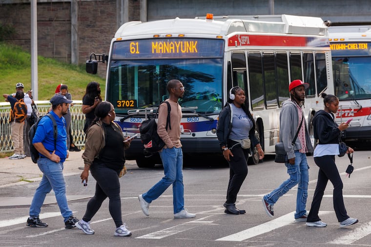 Morning commuters transfer from one bus to another at SEPTA's Wissahickon Transportation Center on Aug. 25, 2025.