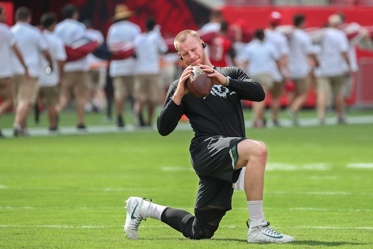Carson Wentz stretches during warm-ups on Sunday at Tampa's Raymond James Stadium.
