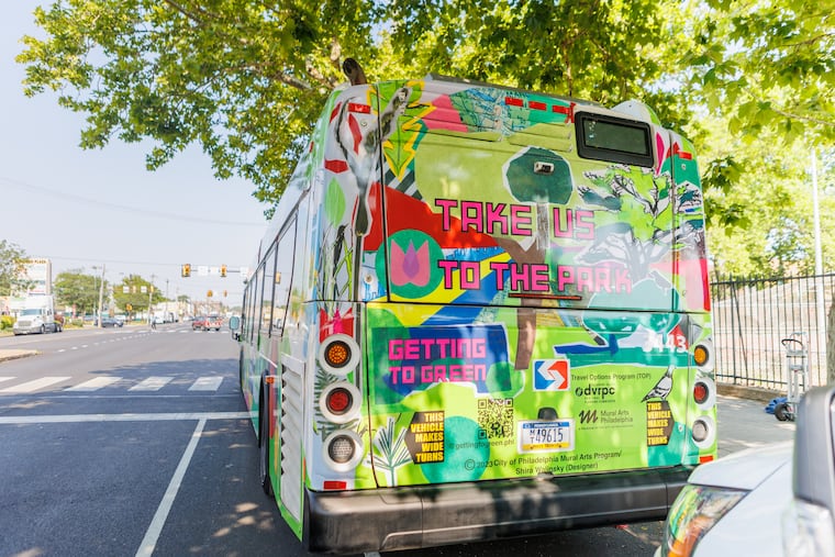 A SEPTA bus is parked at Fourth Street and Oregon Avenue during the unveiling of a new SEPTA Route 7 bus wrap as part of a collaboration between Mural Arts Philly and SEPTA to get people to use public transportation to get to the city's green spaces.