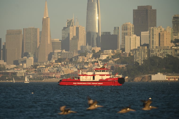 A San Francisco Fire Department vessel passes the city skyline while searching for missing victims after a boat accident near Alcatraz Island off San Francisco, Tuesday, July 14, 2026.