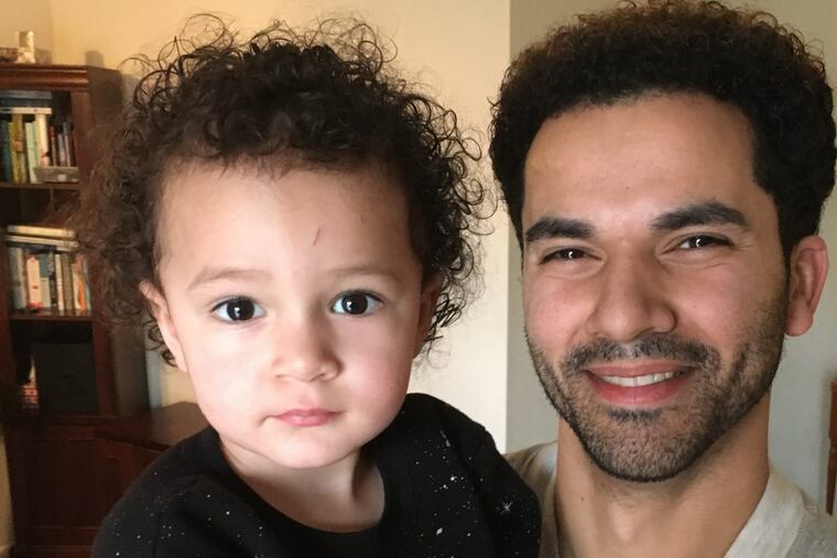 Dreamer Miguel Dalmau holds his 2-year-old son Luka, who is an American citizen.