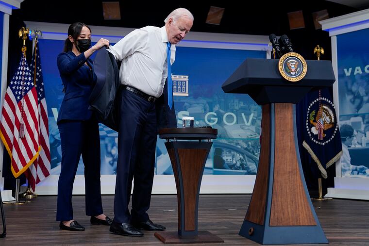 President Joe Biden receives his COVID-19 booster from a member of the White House medical unit.