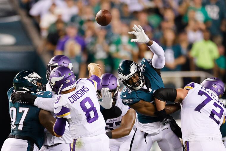 Eagles defensive end Josh Sweat goes after the football against Minnesota Vikings quarterback Kirk Cousins on Sept. 19, 2022.